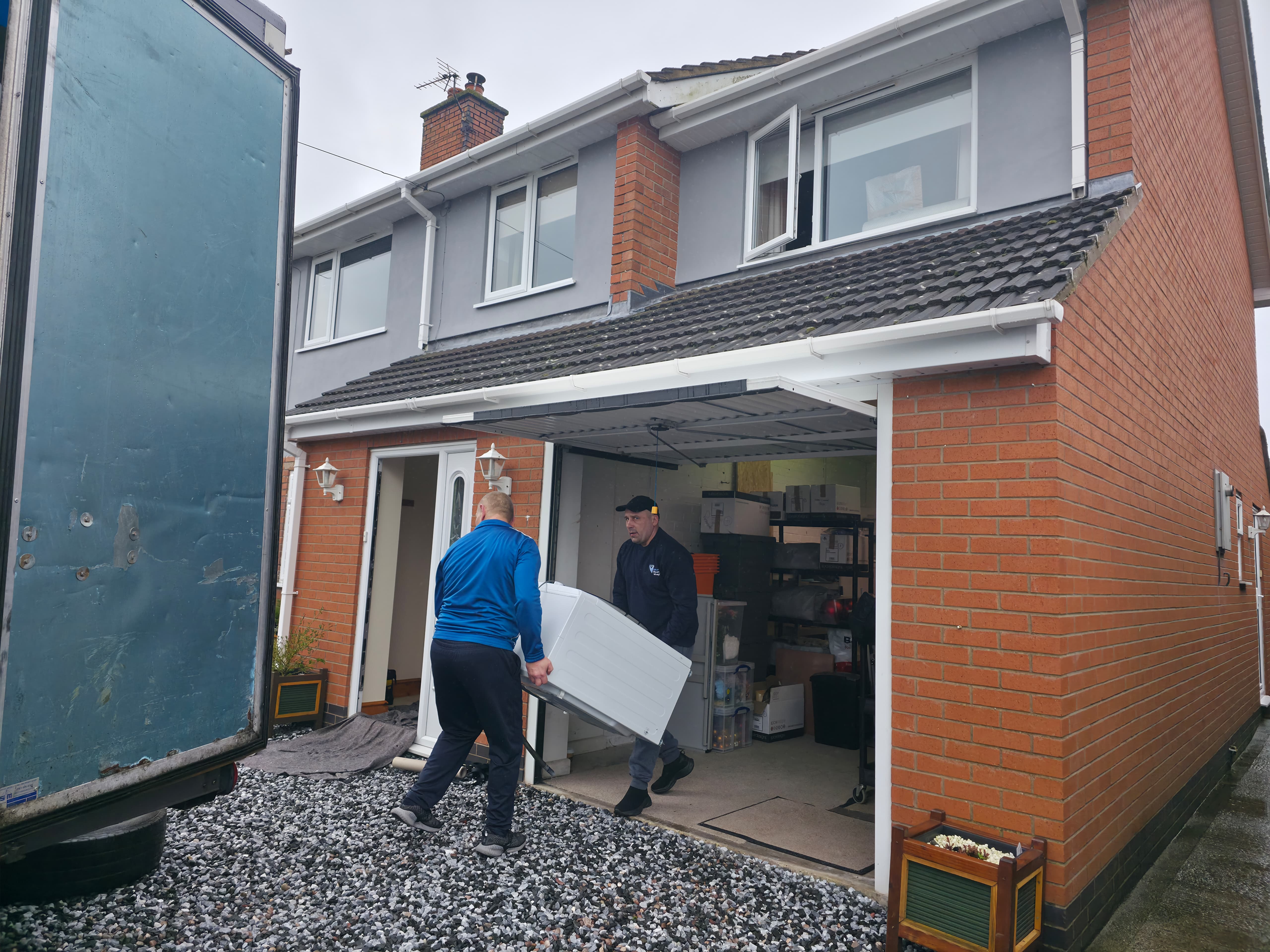 VIP House Movers team carefully carrying large items into a client’s new UK home