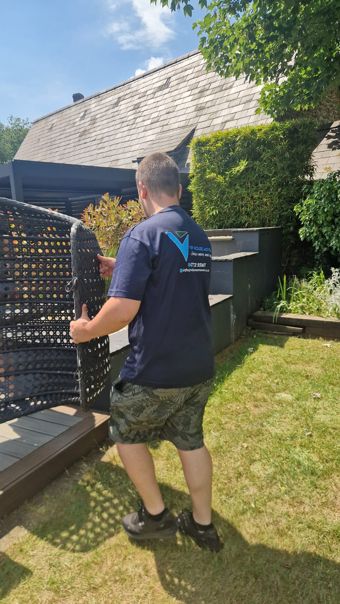 VIP House Movers team carefully carrying outdoor furniture during a garden move